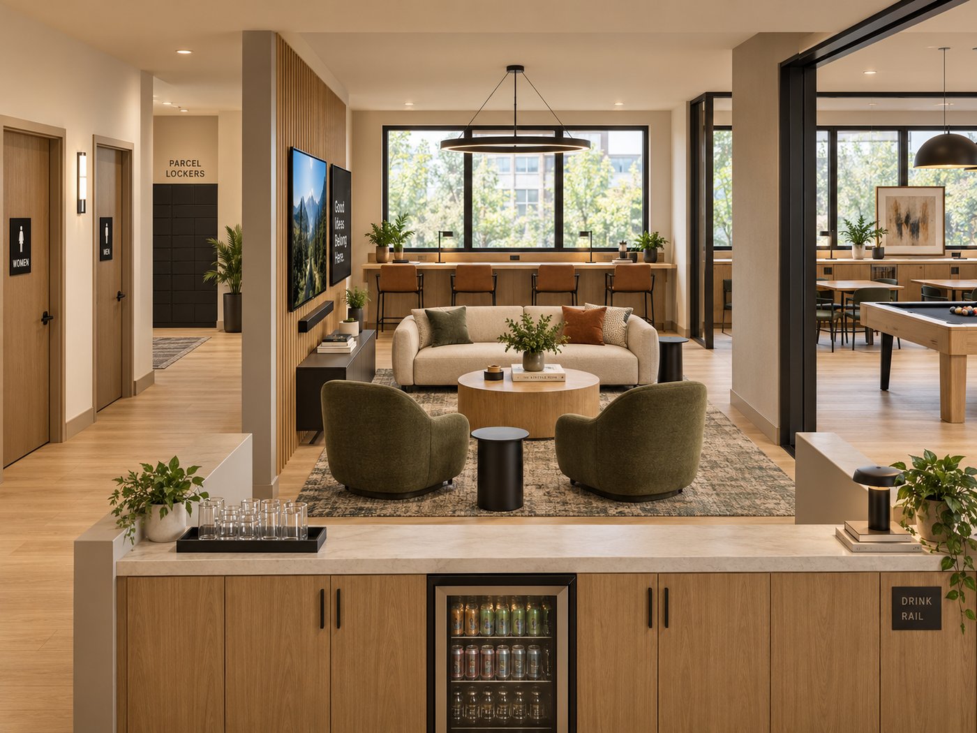 Shared coworking and lounge space with a bar counter, seating, and a games area